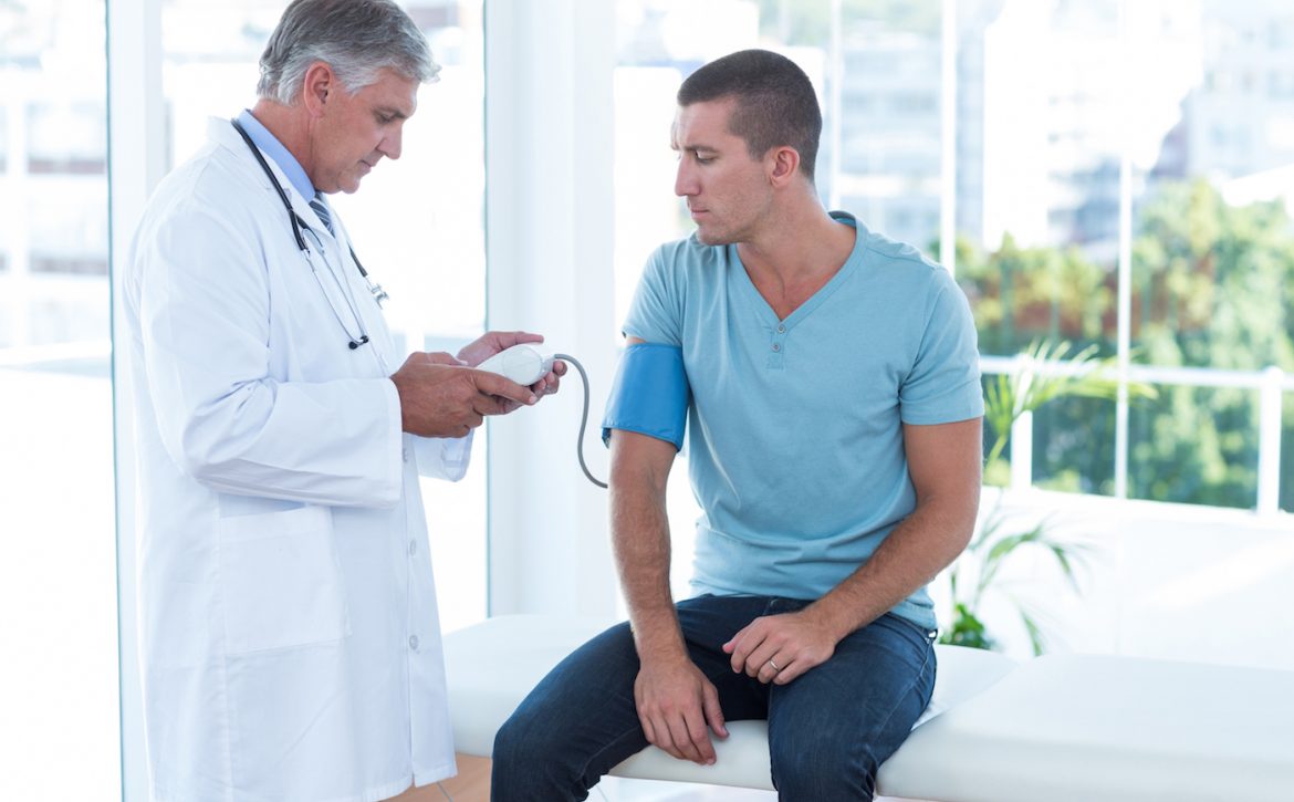 Doctor examining his patients blood pressure